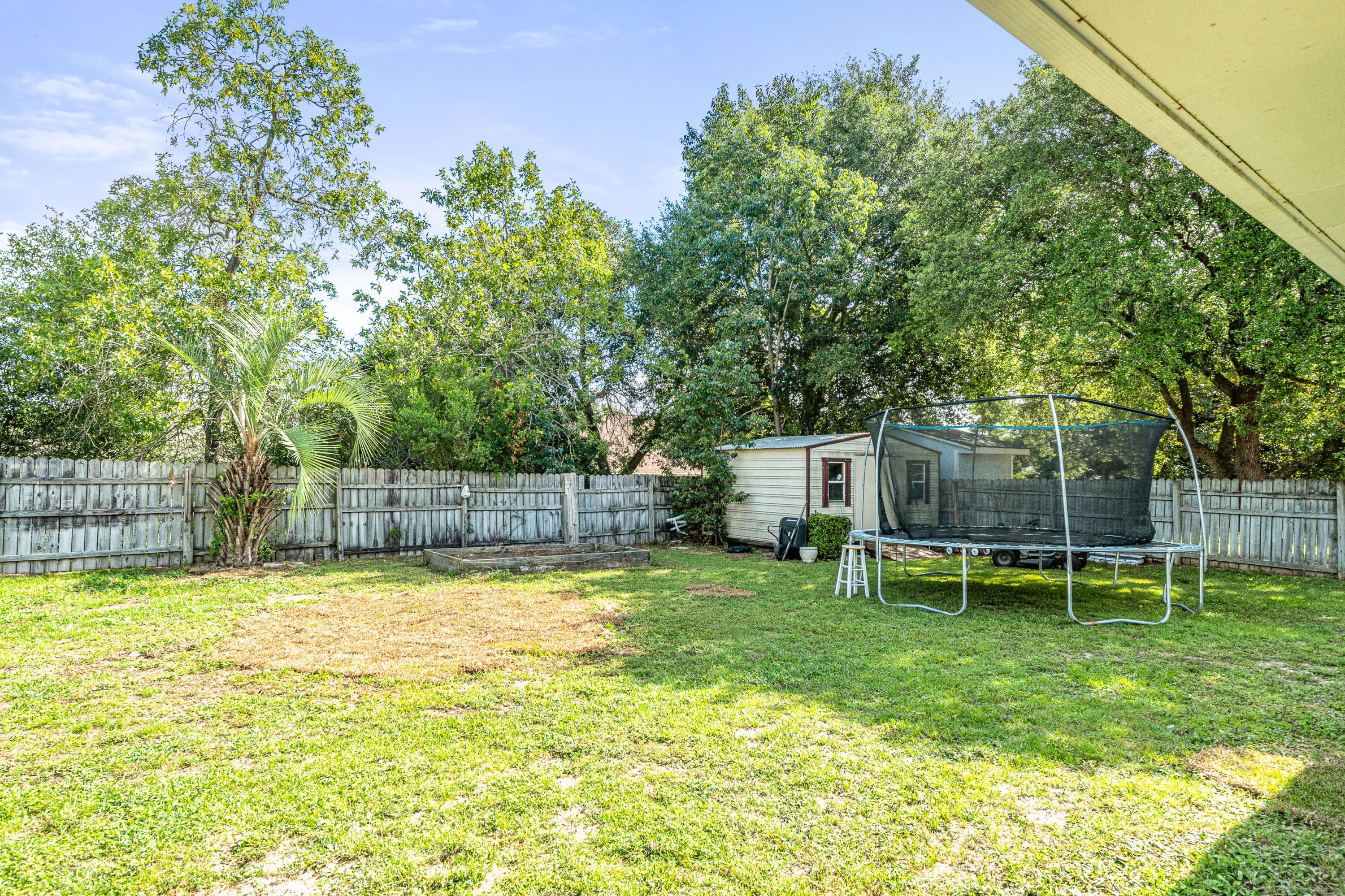 2813 Atoka Trail Crestview, FL 32539 - Photo 28 of 29 a view of a backyard with a swimming pool
