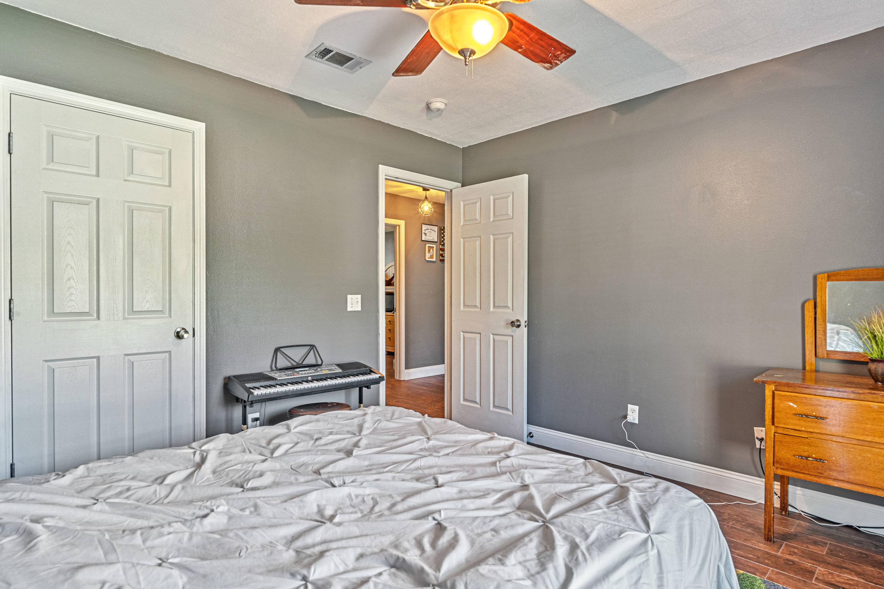 2813 Atoka Trail Crestview, FL 32539 - Photo 8 of 29 a bedroom with a bed and a chandelier