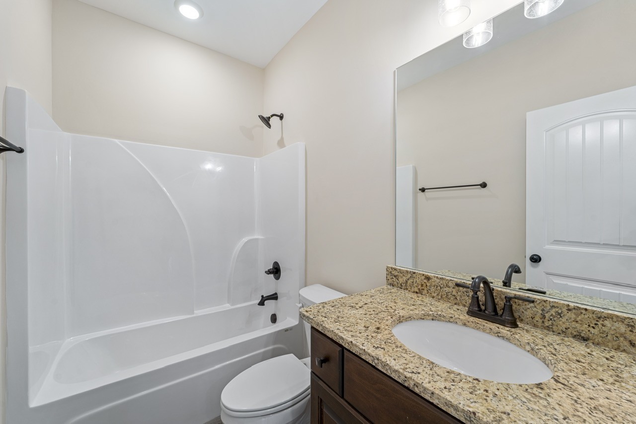 541 Clearview Road Cottontown, TN 37048 - Photo 13 of 18 a bathroom with a granite countertop tub sink toilet shower and mirror