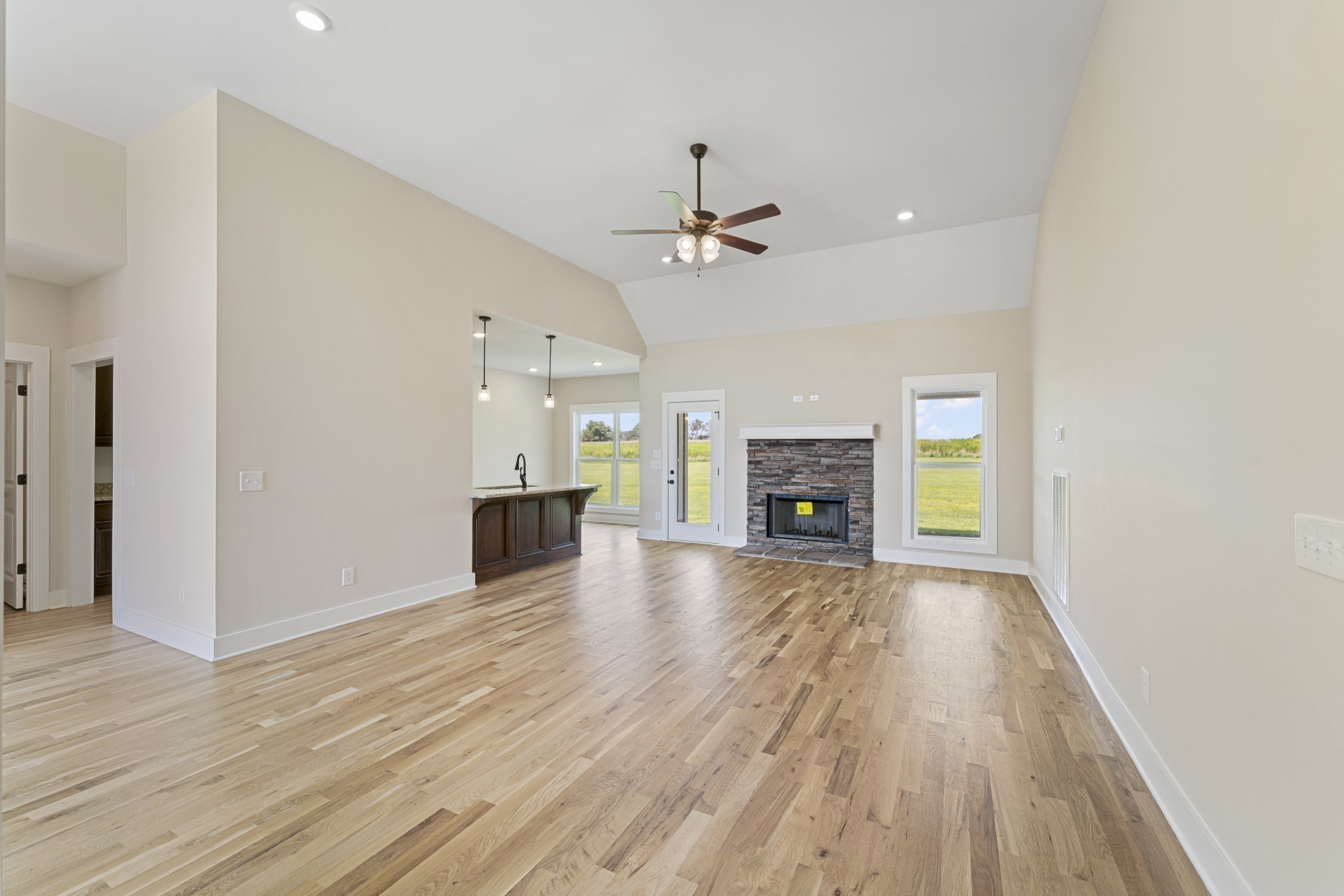 541 Clearview Road Cottontown, TN 37048 - Photo 2 of 18 a view of a livingroom with a fireplace a ceiling fan and wooden floor