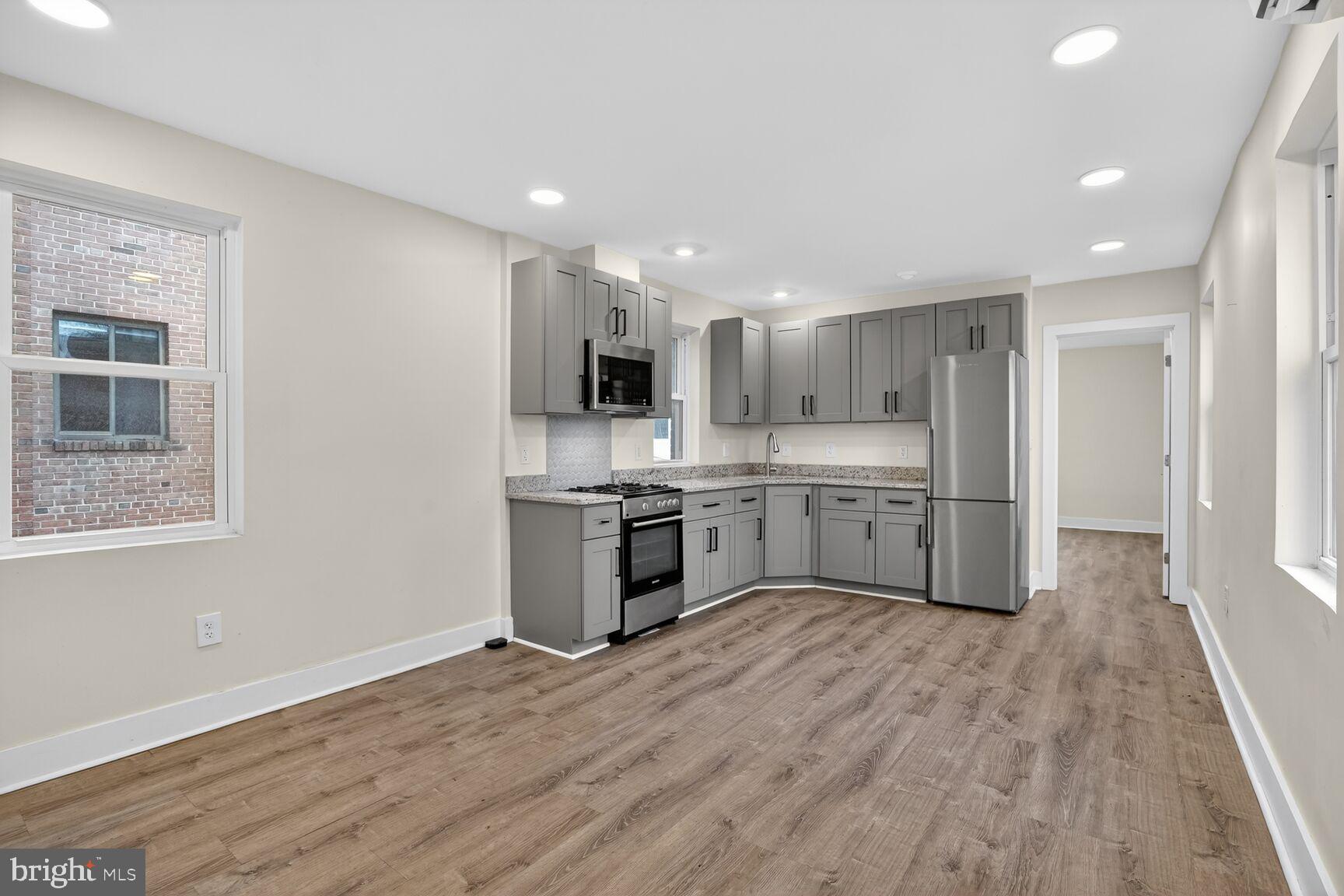 1821 T Street Northwest Washington, DC 20009 - Photo 14 of 40 a large kitchen with a center island and wooden floor