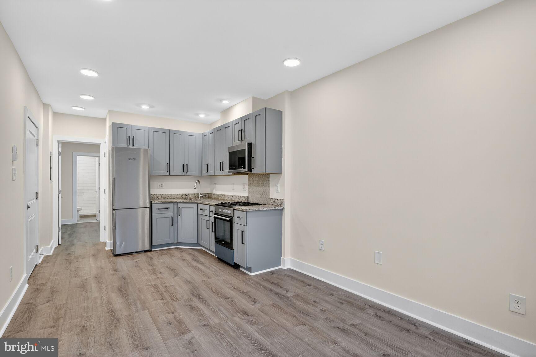 1821 T Street Northwest Washington, DC 20009 - Photo 7 of 40 a kitchen with stainless steel appliances granite countertop a refrigerator and a sink