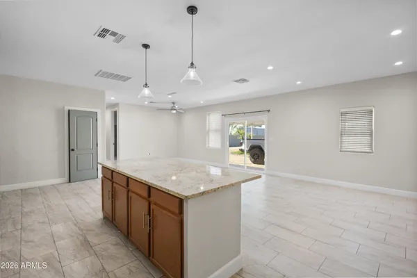 a kitchen with a counter top space and wooden floor