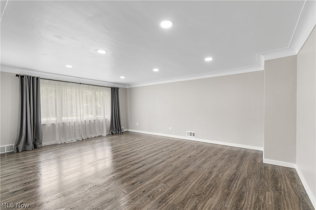10876 West Sprague Road Cleveland, OH 44130 - Photo 5 of 31 Spare room with dark hardwood / wood-style floors and crown molding