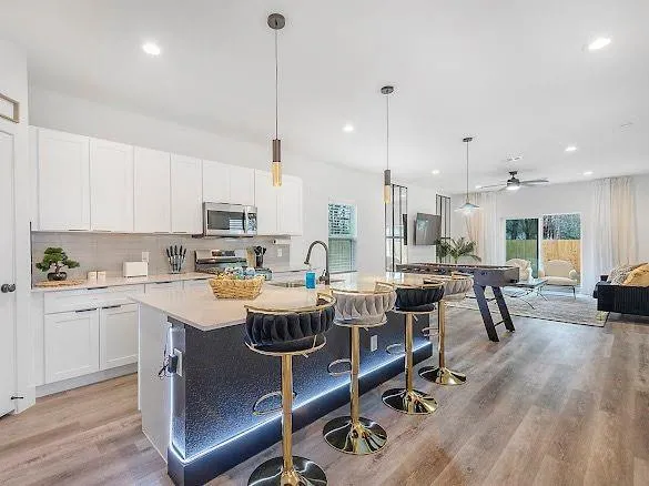 a very nice looking open dining room with kitchen island furniture a rug kitchen view and a center island