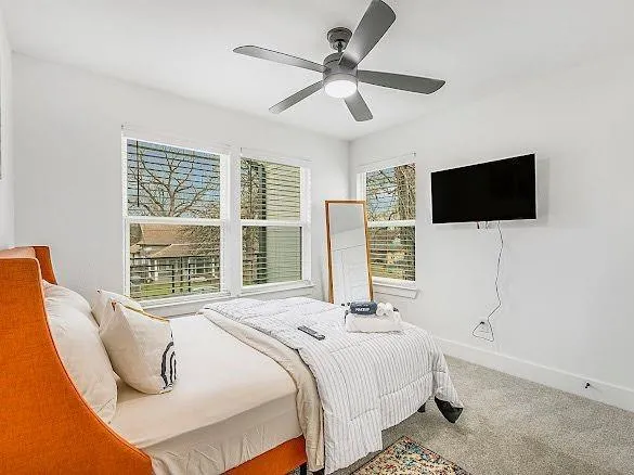 a bedroom with a bed and a flat screen tv