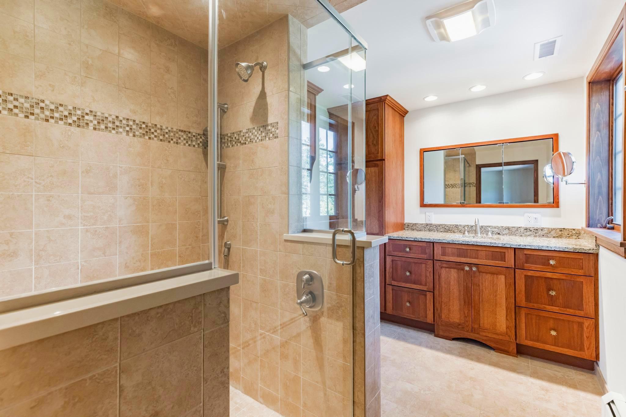 444 Shady Lane Moorestown, NJ 08057 - Photo 20 of 46 a bathroom with a granite countertop sink mirror and a bathtub
