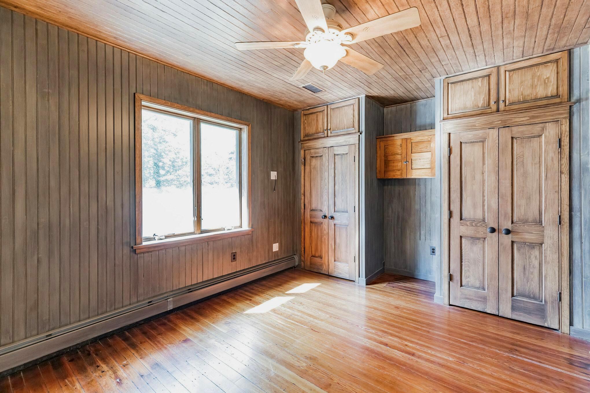 444 Shady Lane Moorestown, NJ 08057 - Photo 24 of 46 an empty room with wooden floor cabinet and windows