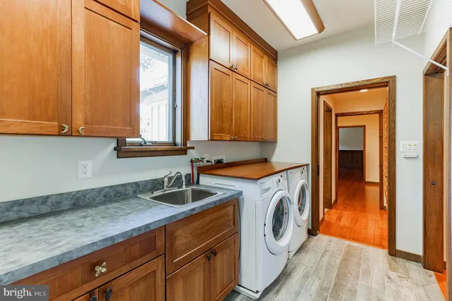 a utility room with a sink a washer and dryer