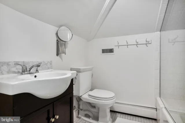 a bathroom with a sink toilet and a mirror