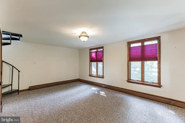 a view of an empty room with windows