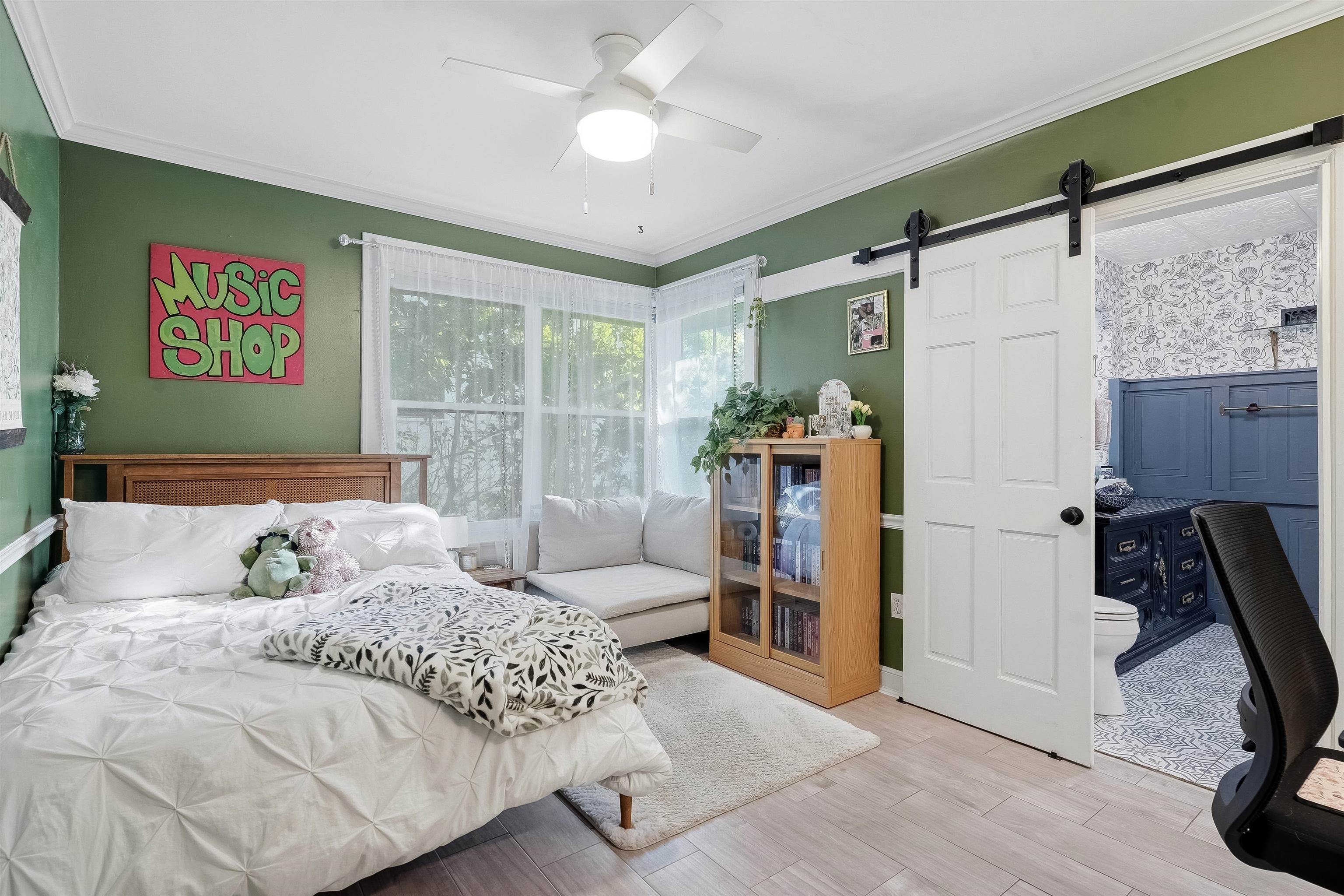 71 Water Street St. Augustine, FL 32084 - Photo 16 of 57 Bedroom with a barn door, crown molding, light wood-style floors, and a ceiling fan