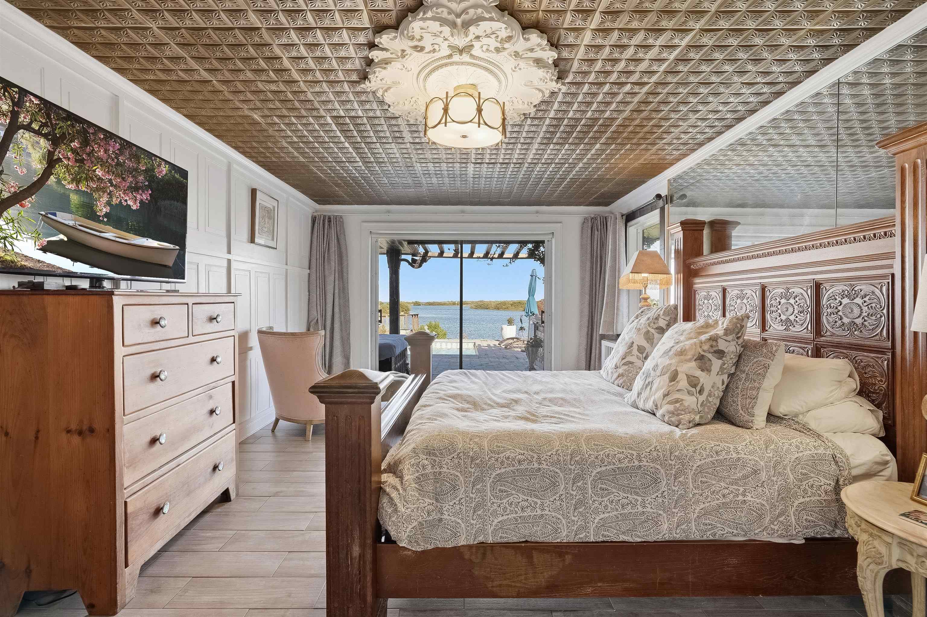 71 Water Street St. Augustine, FL 32084 - Photo 25 of 58 a bedroom with a large bed and a tv