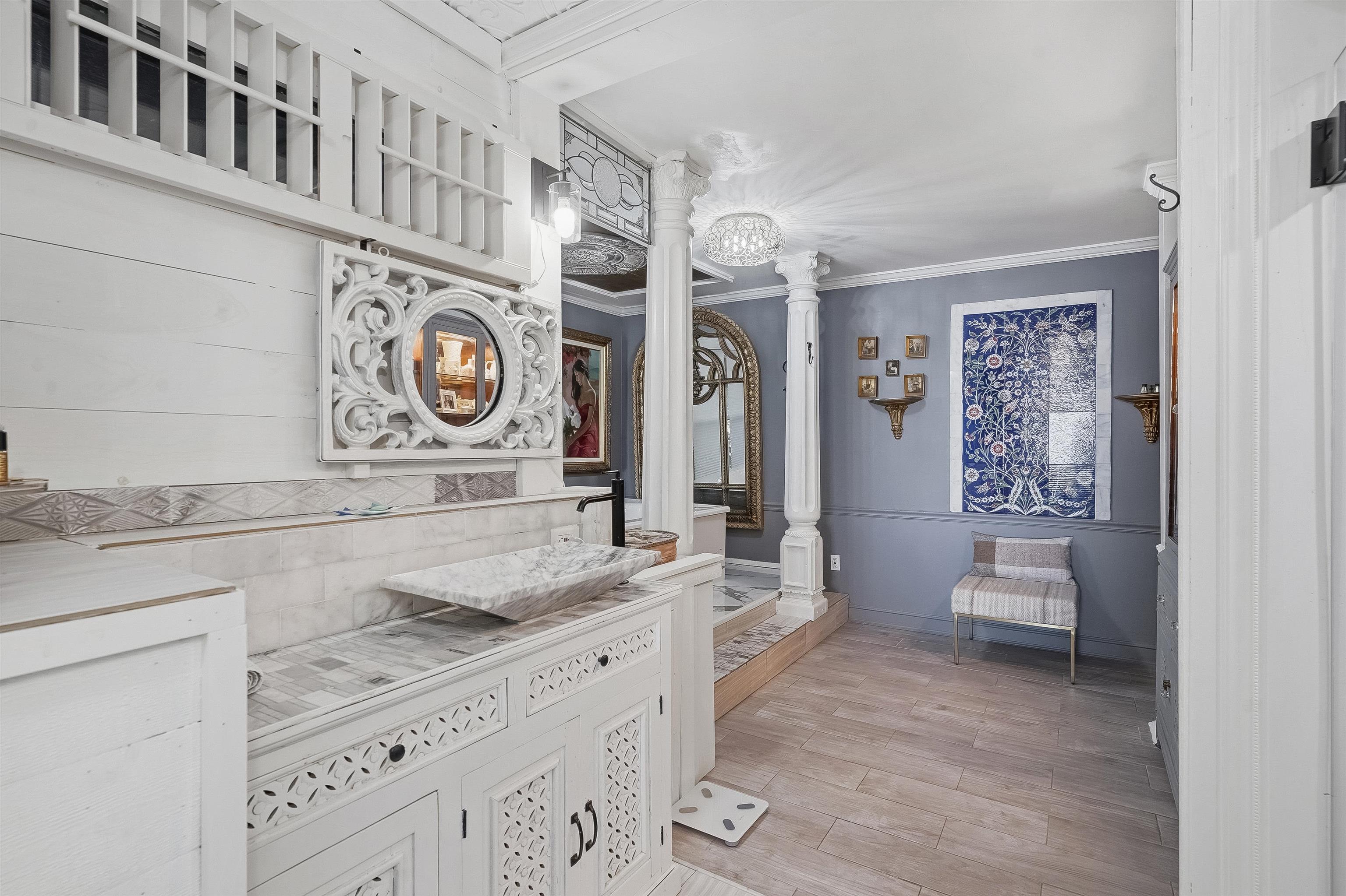71 Water Street St. Augustine, FL 32084 - Photo 27 of 58 Ensuite bathroom featuring ornate columns, light wood finished floors, vanity, and ornamental molding.