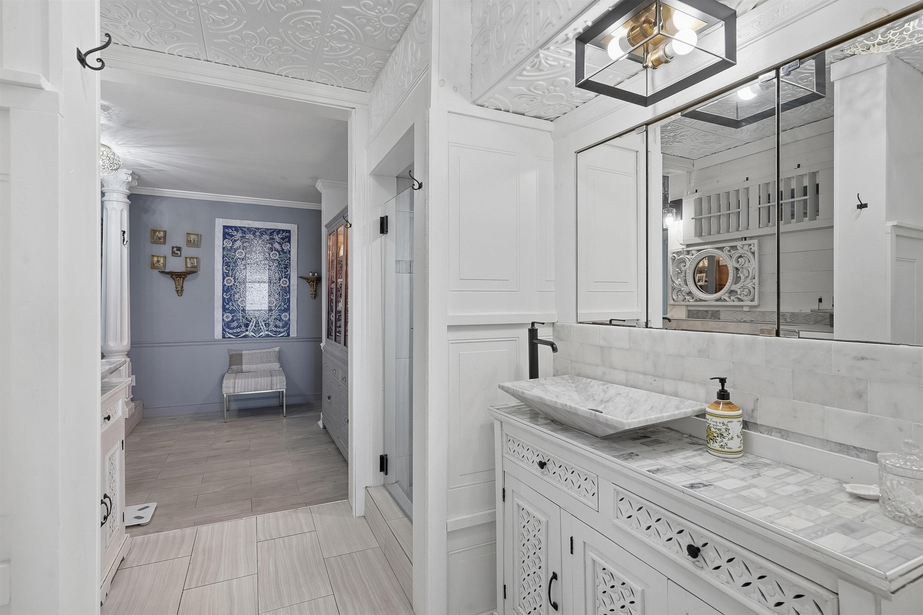 71 Water Street St. Augustine, FL 32084 - Photo 28 of 58 a bathroom with a granite countertop sink mirror and shower