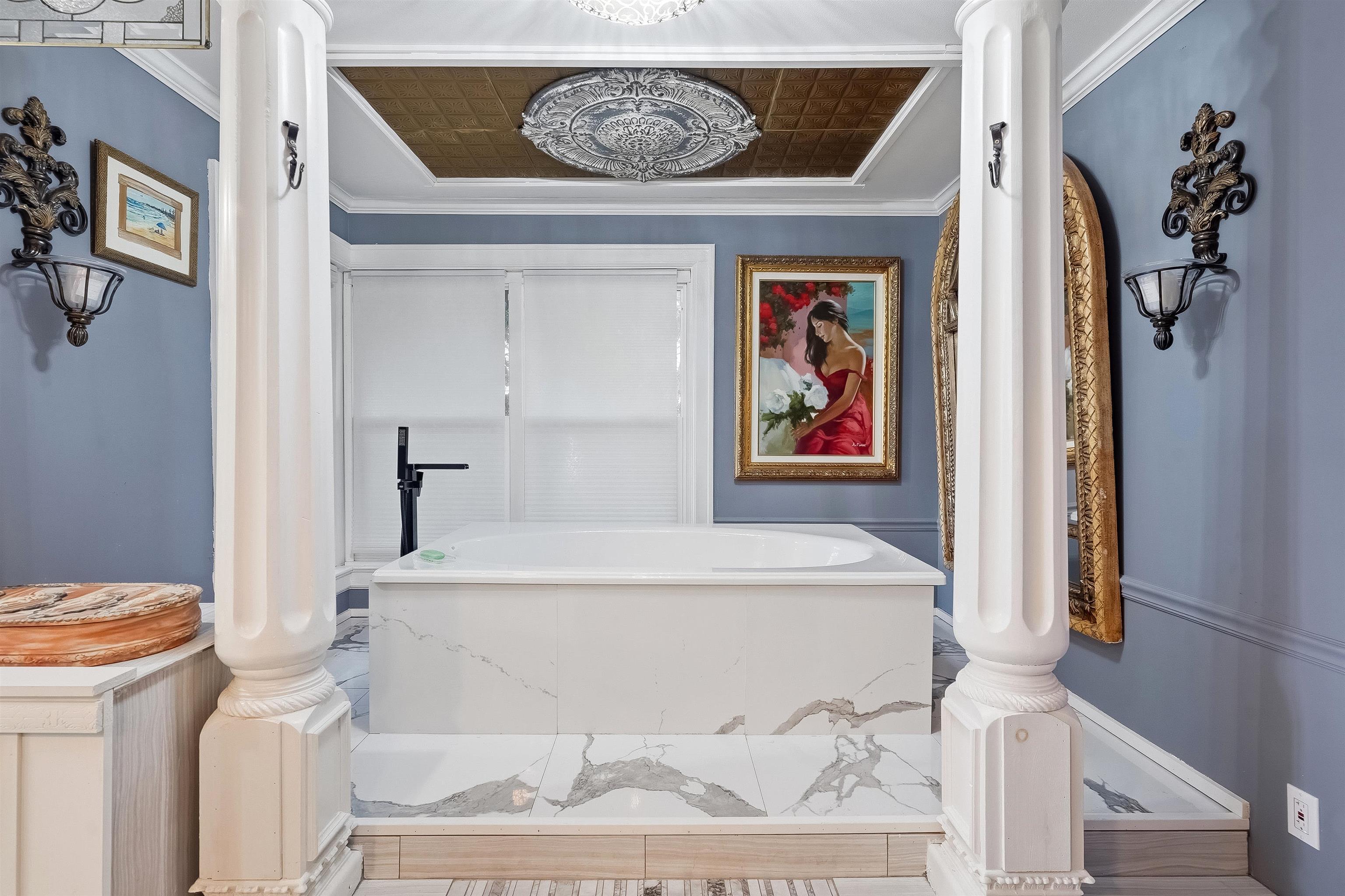 71 Water Street St. Augustine, FL 32084 - Photo 29 of 58 a white bath tub sitting next to a white sink and vanity