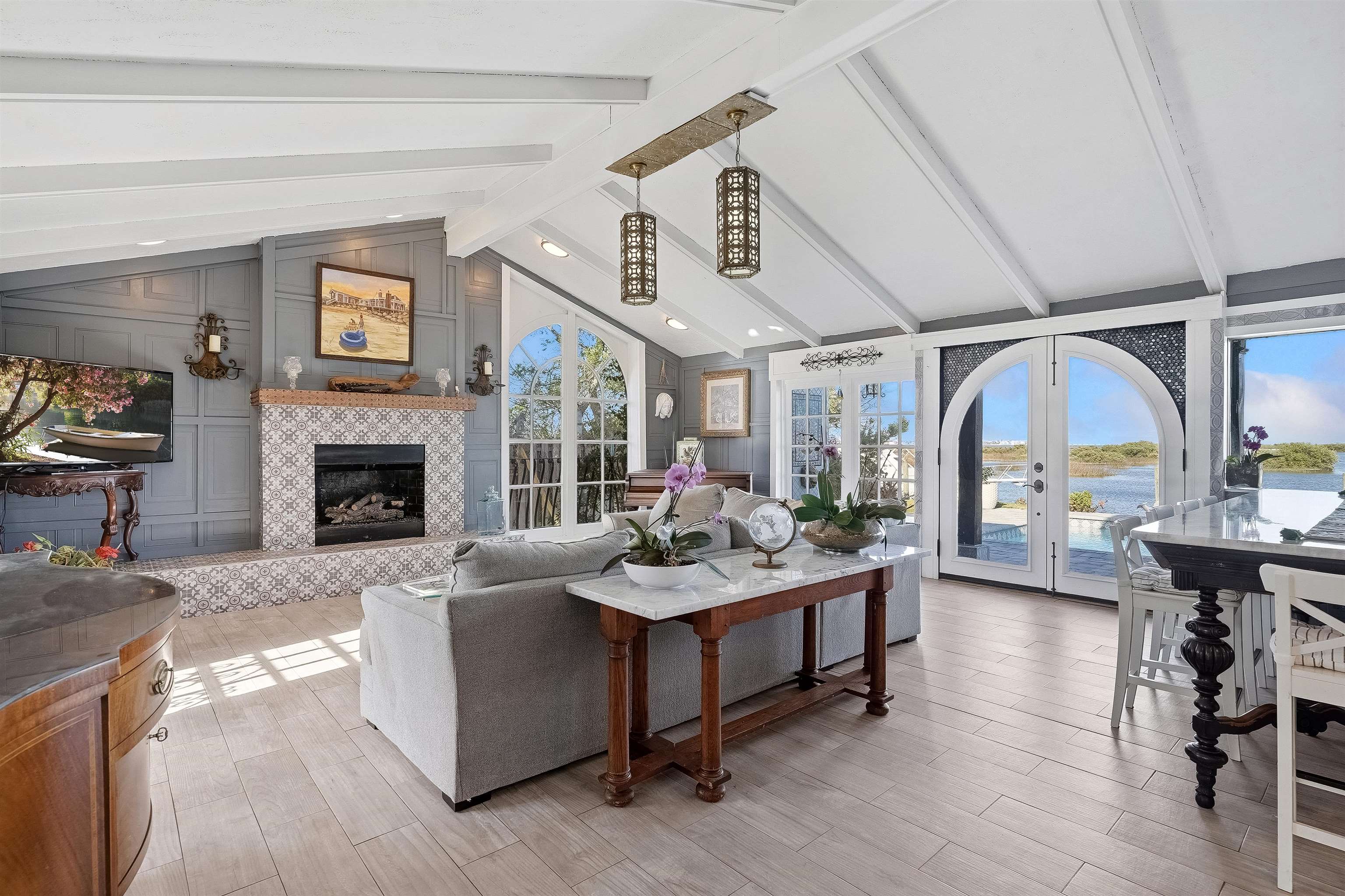 71 Water Street St. Augustine, FL 32084 - Photo 36 of 57 Living area featuring french doors, a gas fireplace, light wood-style floors, beamed ceiling, and an abundant amount of natural light