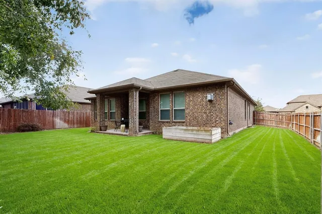 a view of a house with a yard and porch