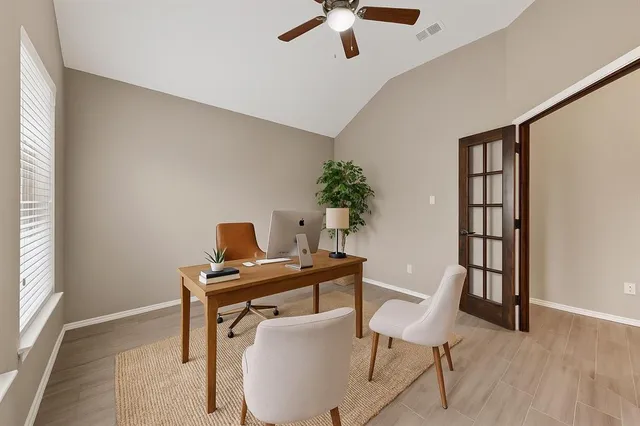 a view of a workspace with furniture and wooden floor