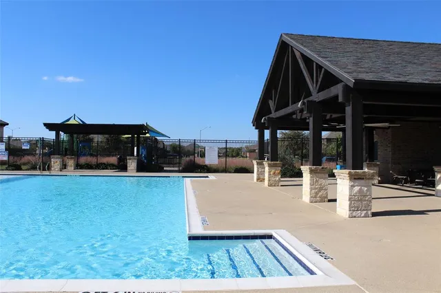 a view of a patio with table and chairs a barbeque with wooden floor and fence