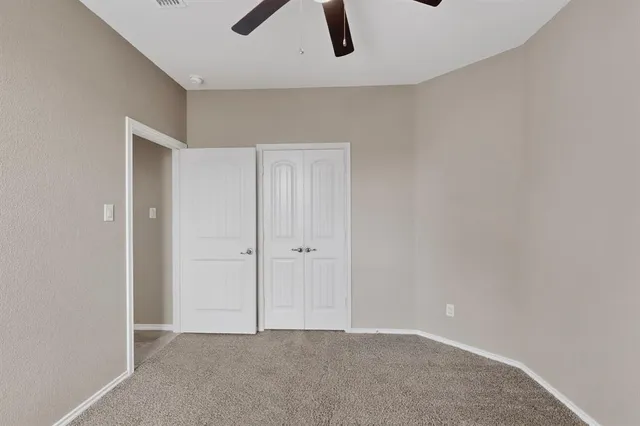 an empty room with ceiling fan