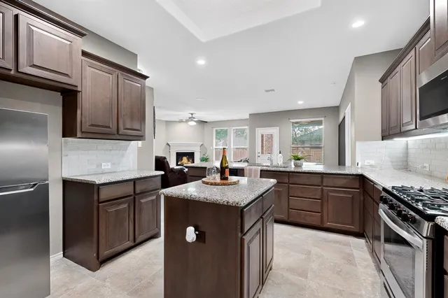 a kitchen with stainless steel appliances granite countertop a sink stove oven and refrigerator
