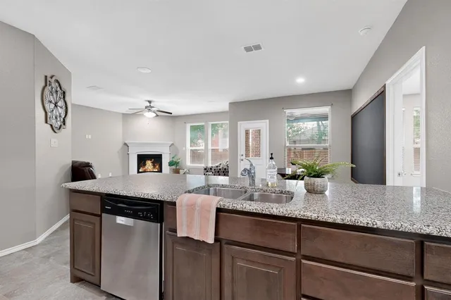 a kitchen with granite countertop cabinets a sink and a stove