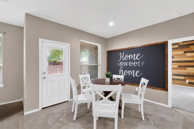 a dining room with furniture and window