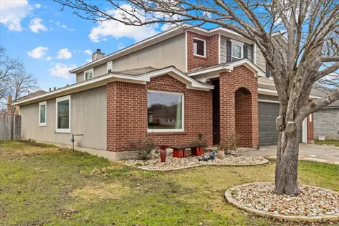 a front view of house with yard patio and fire pit