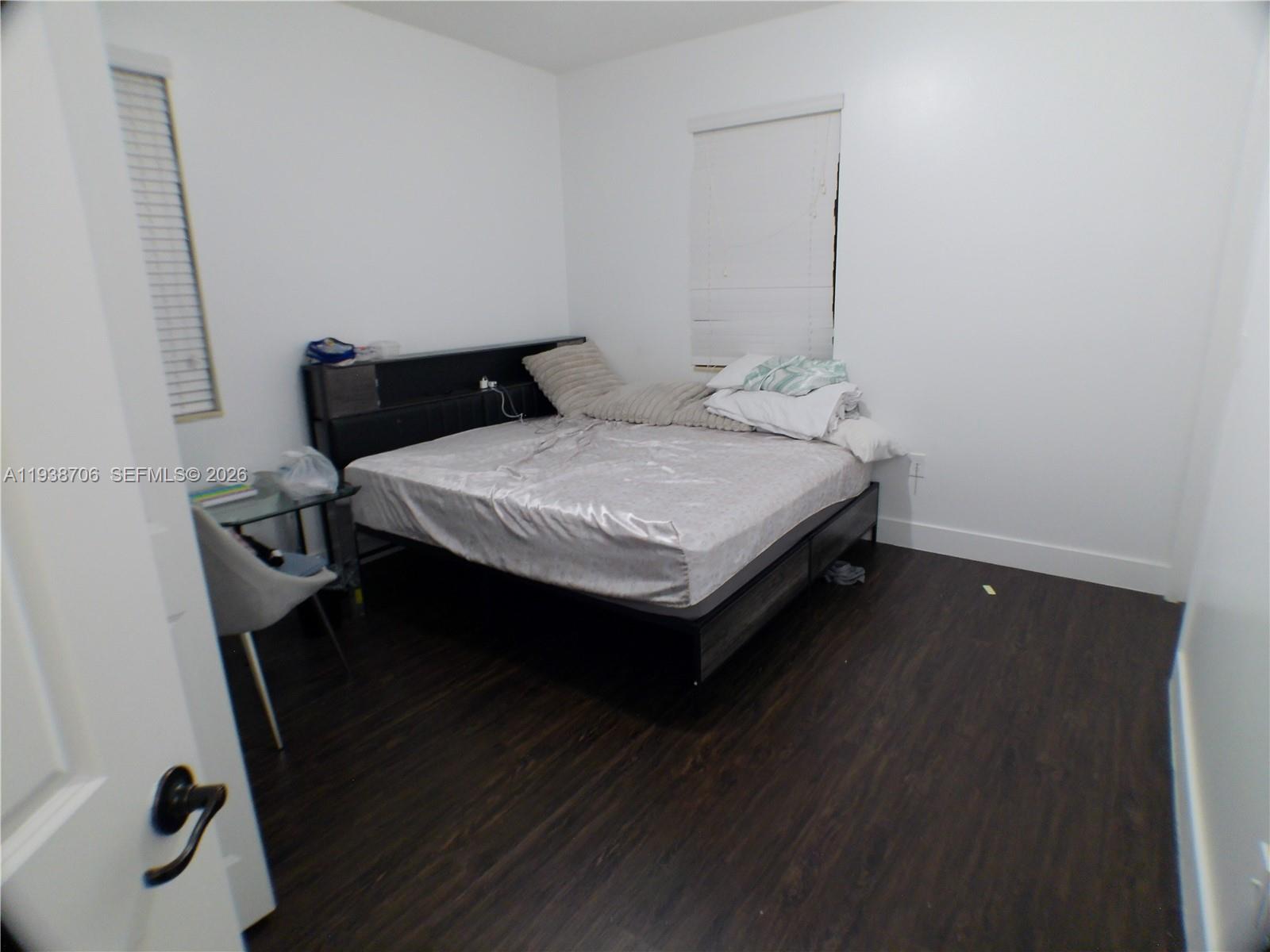 3308 West 95th Terrace Hialeah, FL 33018 - Photo 11 of 29 a bedroom with a bed and wooden floor