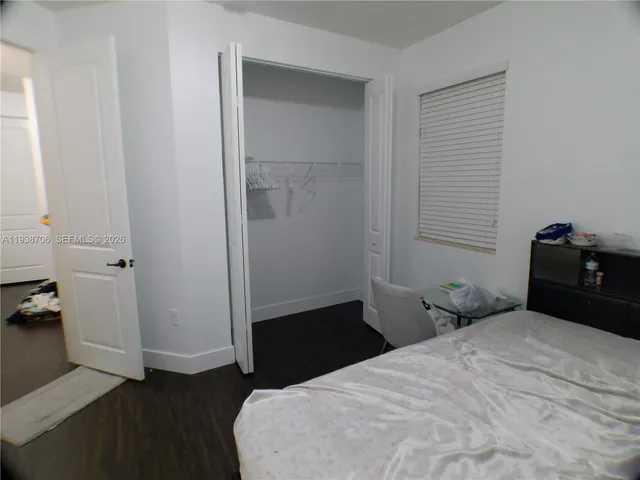 a bedroom with a bed and a closet