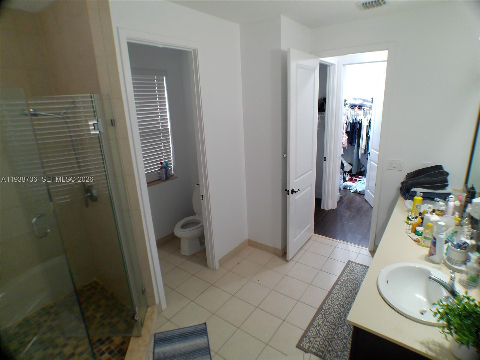 3308 West 95th Terrace Hialeah, FL 33018 - Photo 20 of 29 a bathroom with a sink and a mirror