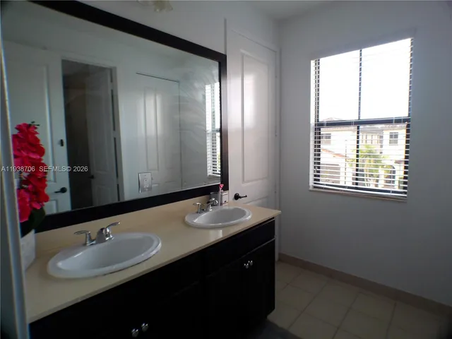 a bathroom with a double vanity sink and a mirror