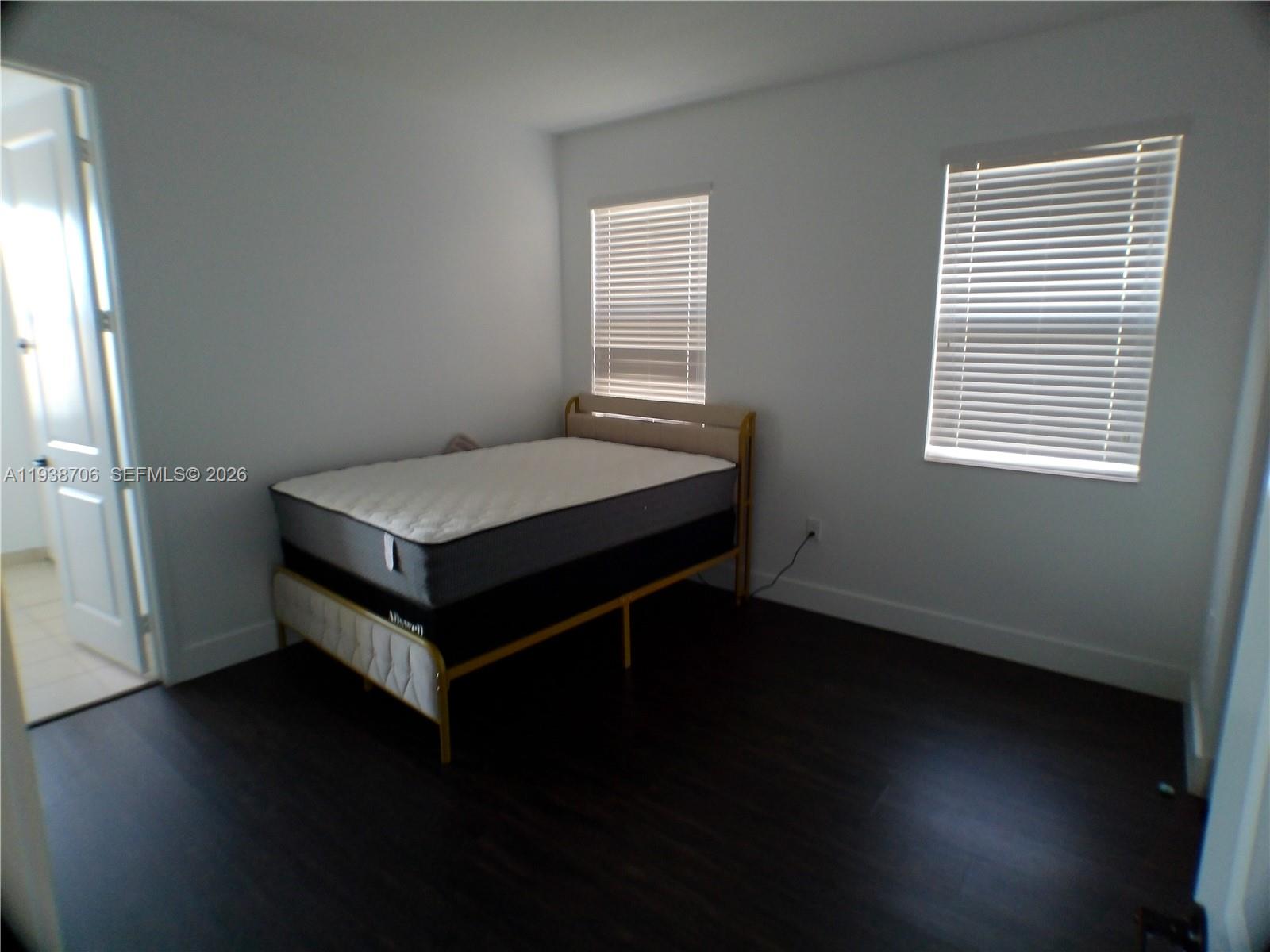 3308 West 95th Terrace Hialeah, FL 33018 - Photo 25 of 29 a room with a bed and a window