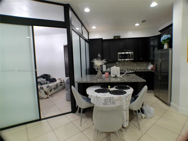 a kitchen with a refrigerator and a stove