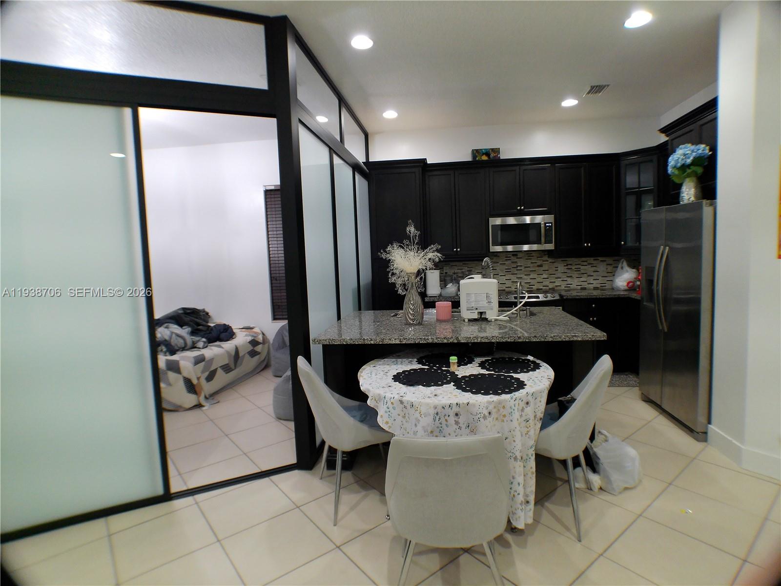 3308 West 95th Terrace Hialeah, FL 33018 - Photo 6 of 29 a kitchen with a refrigerator and a stove