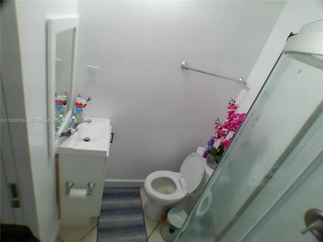 a bathroom with a sink mirror vanity and toilet