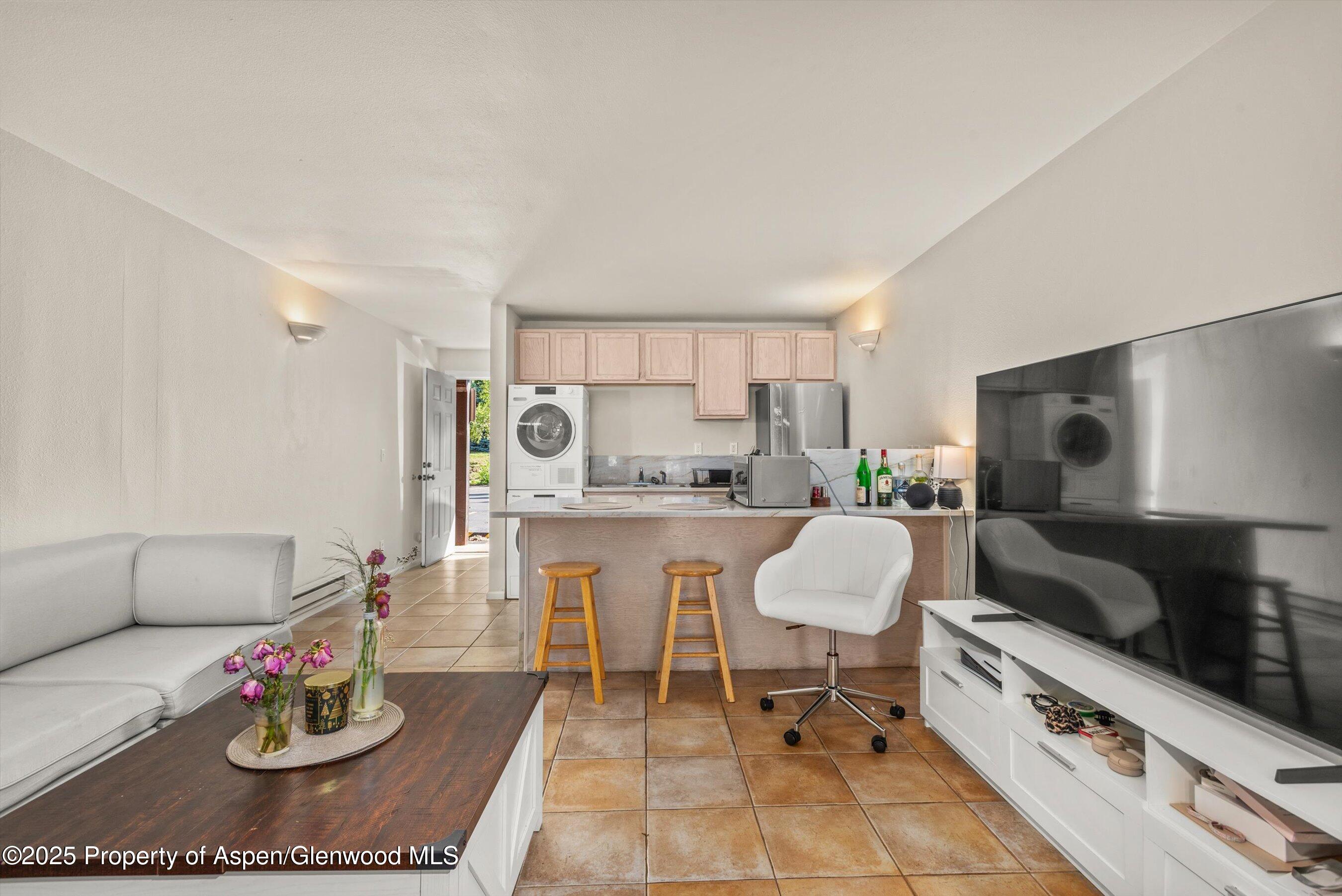 23284 2 Rivers Road, Unit 13 Basalt, CO 81621 - Photo 6 of 16 a living room with furniture and a wooden floor