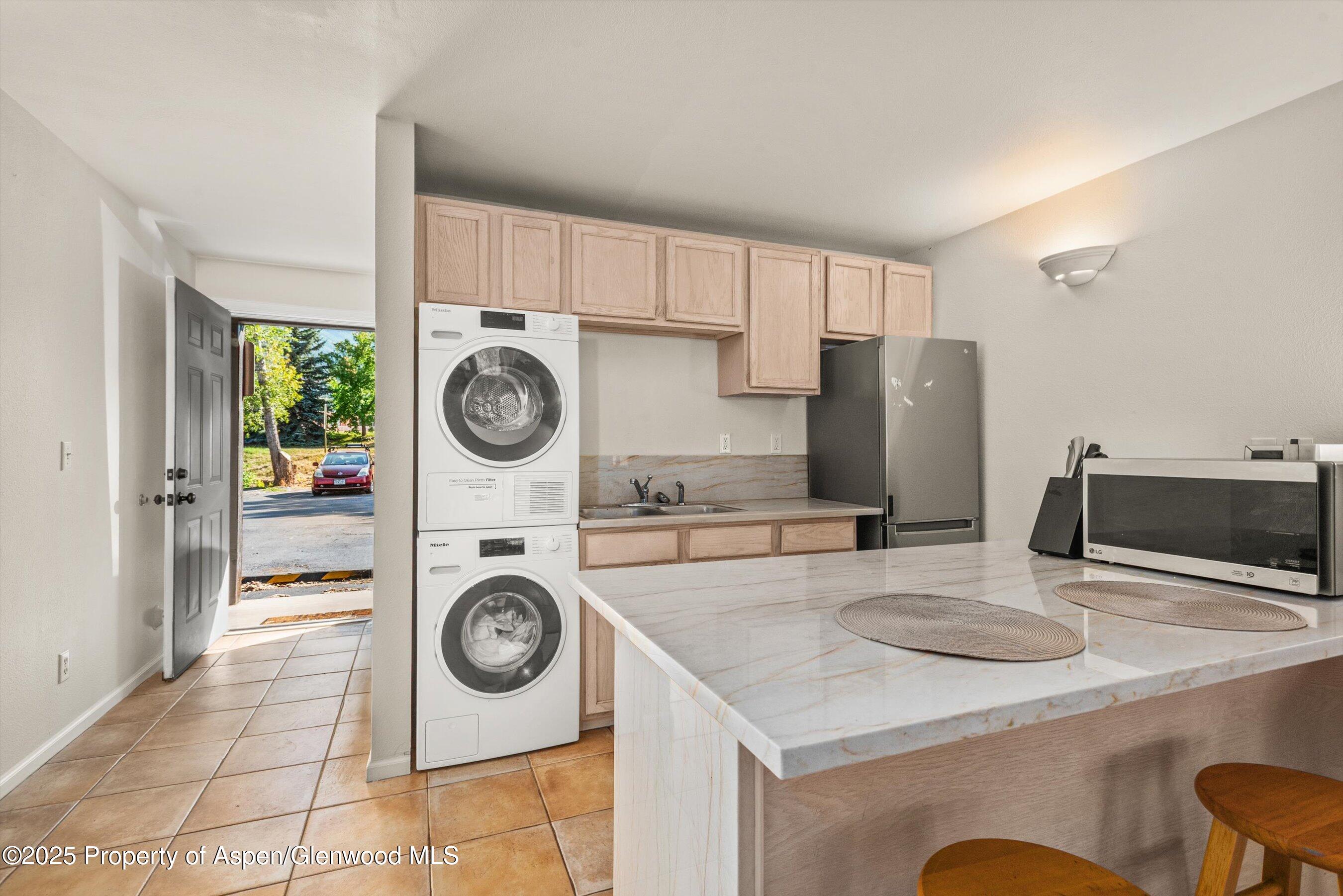 23284 2 Rivers Road, Unit 13 Basalt, CO 81621 - Photo 8 of 16 a kitchen with refrigerator and washer