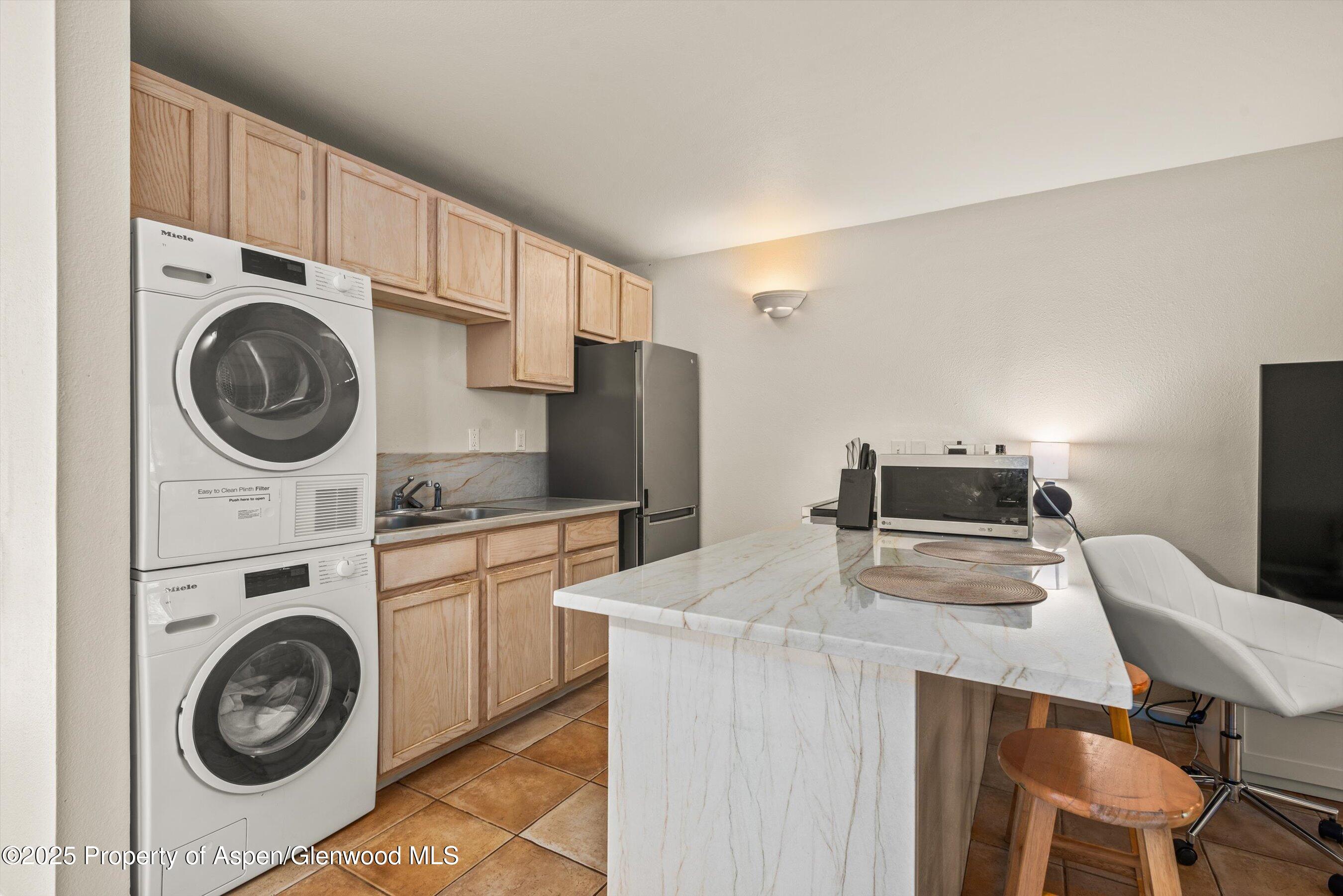 23284 2 Rivers Road, Unit 13 Basalt, CO 81621 - Photo 9 of 16 a utility room with sink dryer and washer