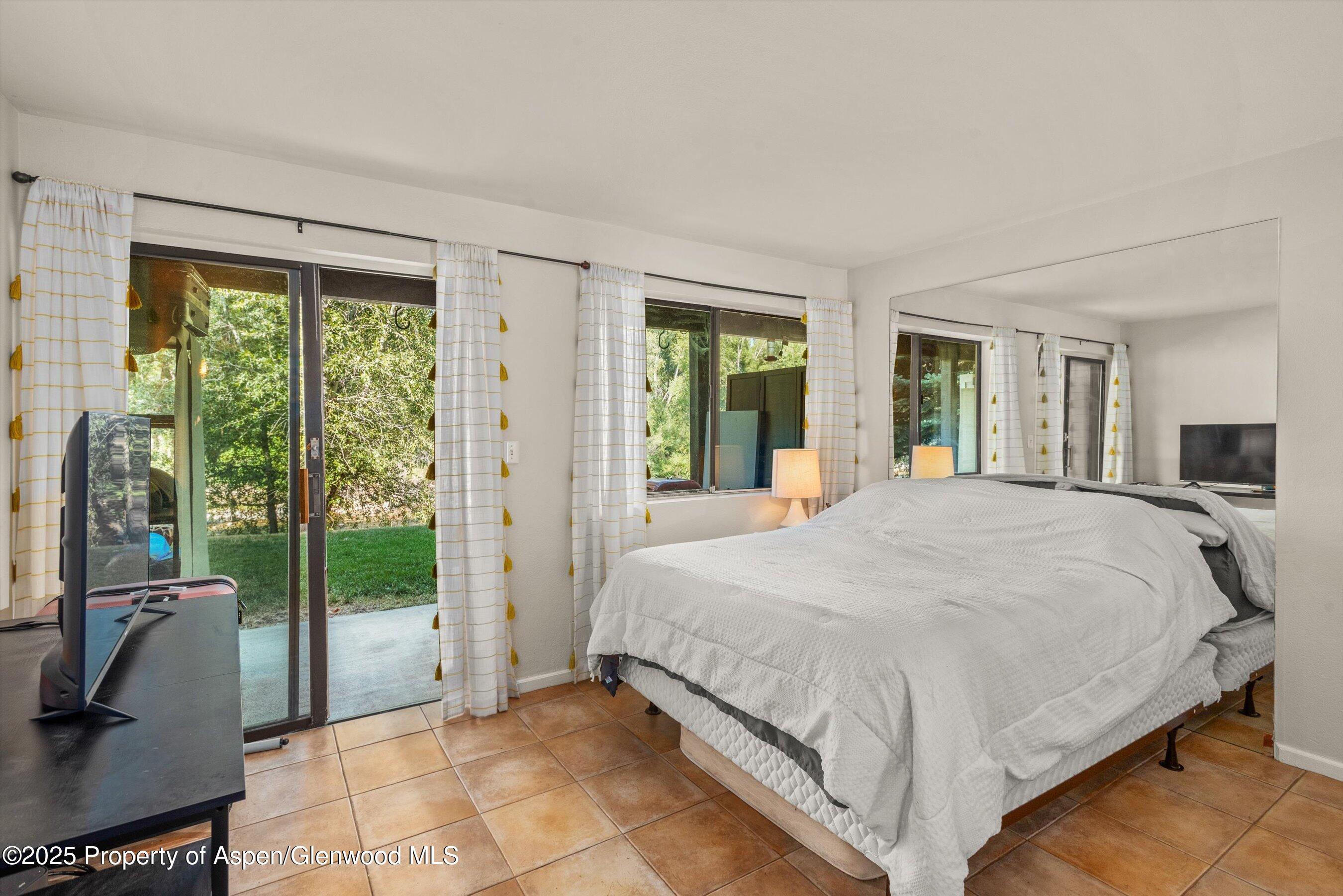 23284 2 Rivers Road, Unit 13 Basalt, CO 81621 - Photo 10 of 16 a bed sitting in a spacious bedroom next to a window