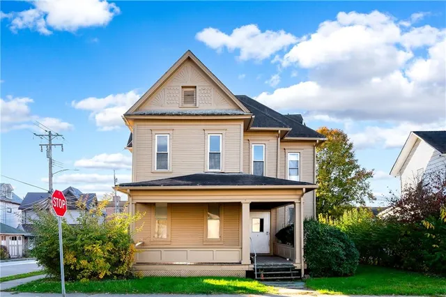 a front view of a house with garden
