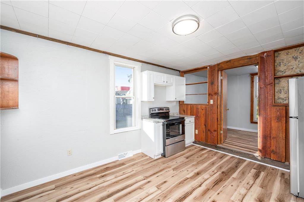 401 West New Castle Street Butler, PA 16001 - Photo 12 of 32 a kitchen with granite countertop a refrigerator and a stove
