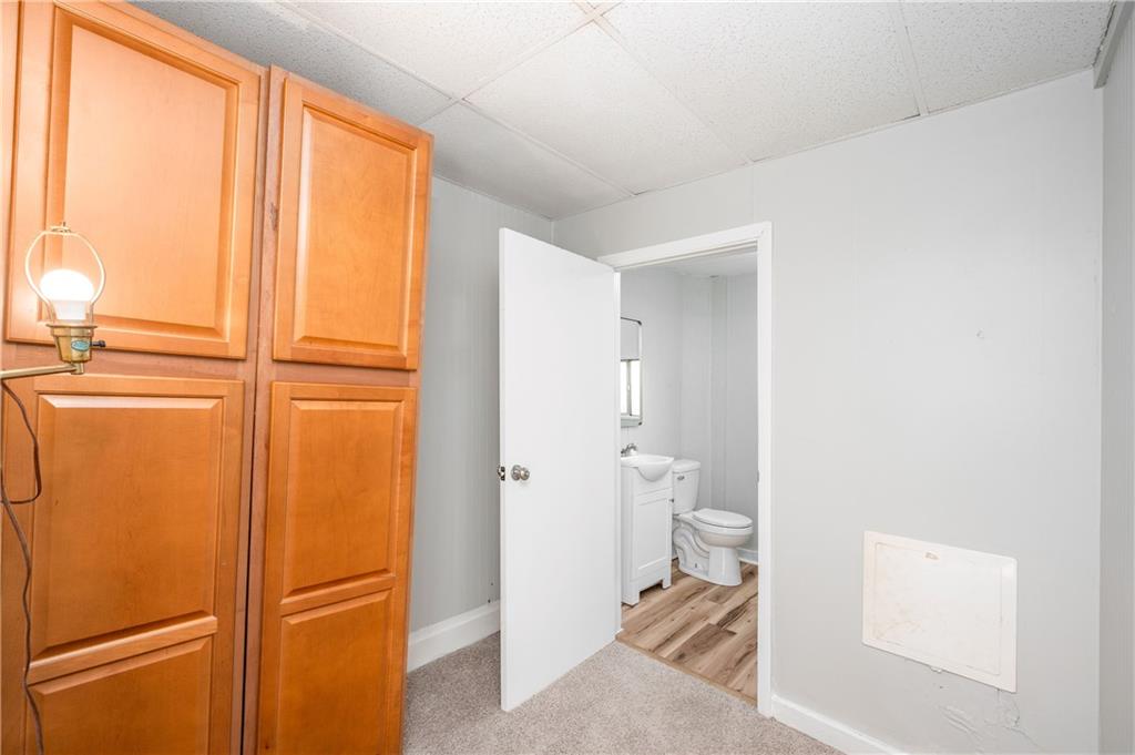 401 West New Castle Street Butler, PA 16001 - Photo 17 of 32 a bathroom with a granite countertop sink and a toilet