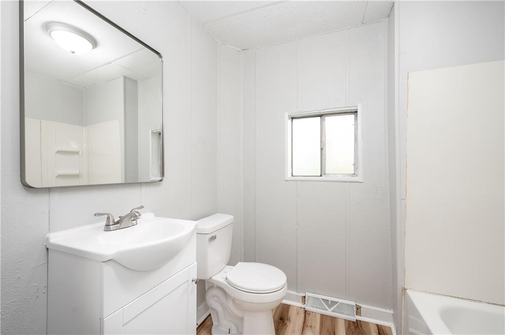 401 West New Castle Street Butler, PA 16001 - Photo 18 of 32 a bathroom with a sink toilet and mirror