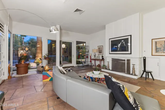 a living room with furniture and kitchen view