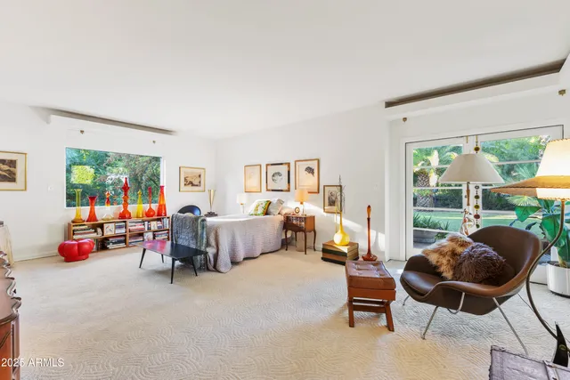 a front view of a house with a yard and palm trees