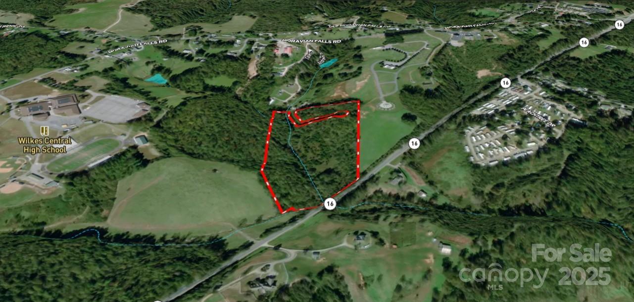 701 Moravian Falls Road Wilkesboro, NC 28697 - Photo 3 of 30 an aerial view of a residential houses with outdoor space and trees