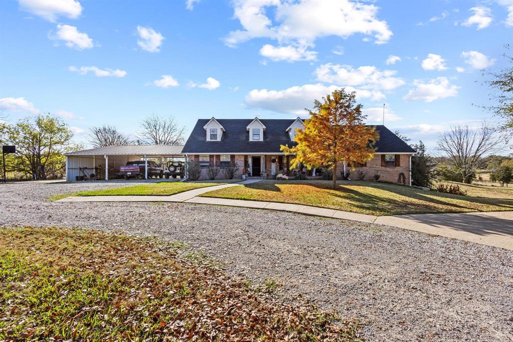 a view of a house with swimming pool and a yard