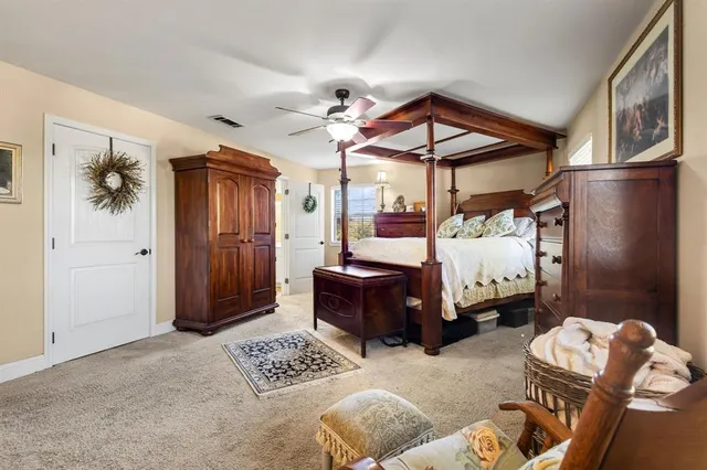 a bedroom with furniture and a chandelier